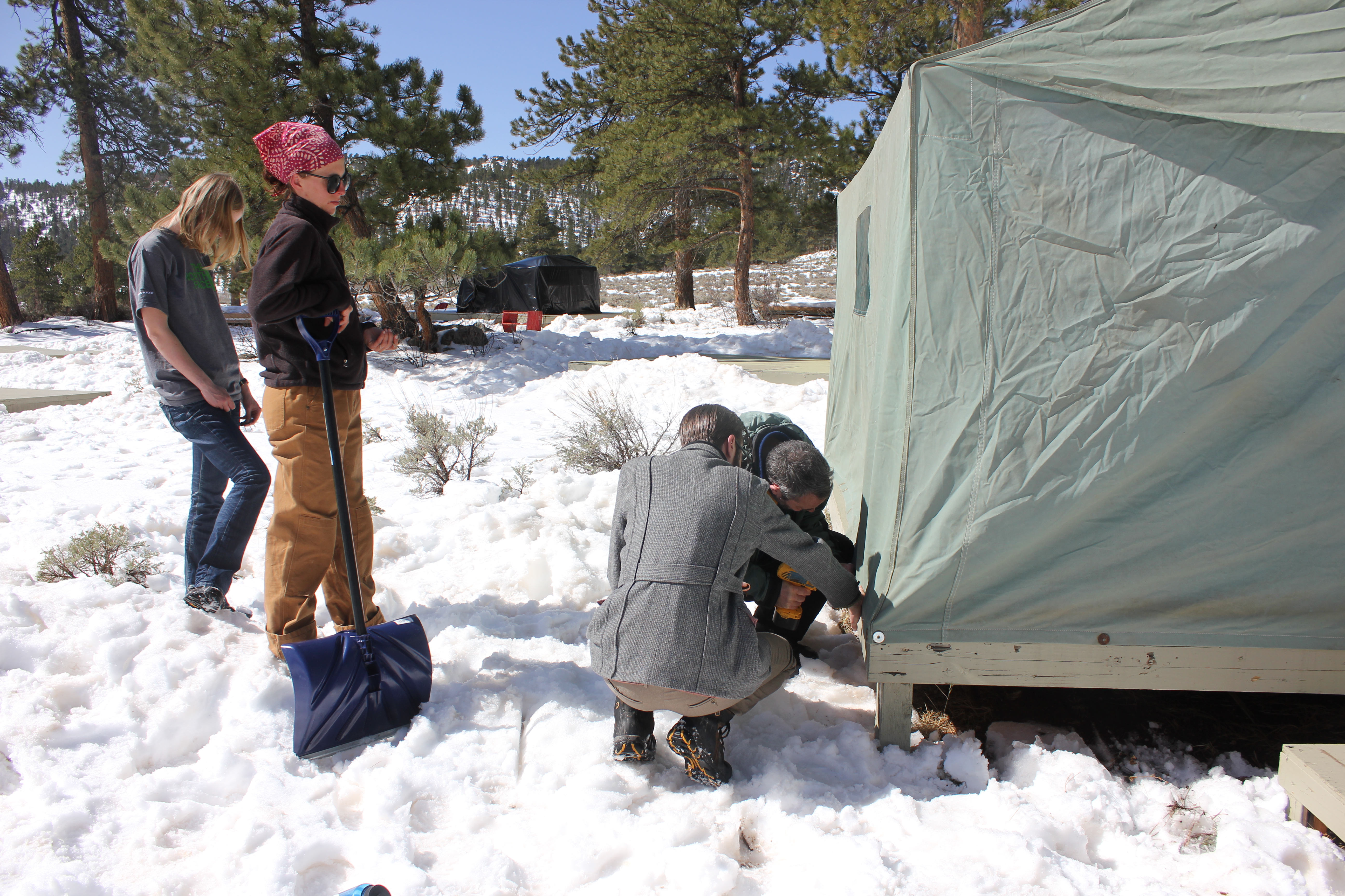 setting up a tent in the snow