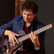 Elden holding a guitar